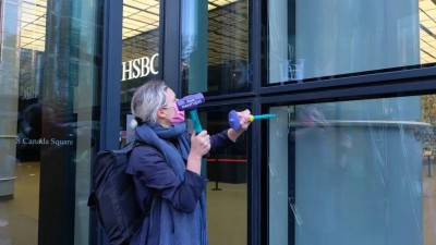 The women used hammers to shatter the glass at HSBC's headquarters in Canary Wharf