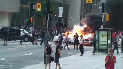 Bank of Montreal windows smashed, police car on fire
