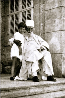 Abdu'l-Baha with a child outside His house in Haifa-1.jpg