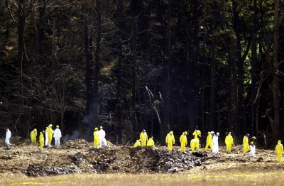 Investigators examine the impact crater at the Flight 93 crash site, Shanksville, Pennsylvania, September 12, 2001