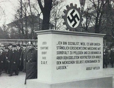German Labour Front (DAF) monument, Dortmund, 1935. The caption translates: “I am a socialist, because it seems incomprehensible to me to care for and treat a machine with care, but to let the noblest representative of work, man himself, degenerate.”