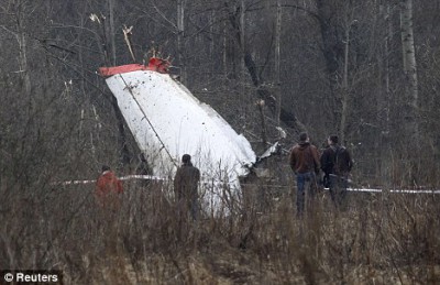 People stand near the wreckage of a Polish government Tupolev Tu-154 aircraft that crashed near Smolensk airport on April 10